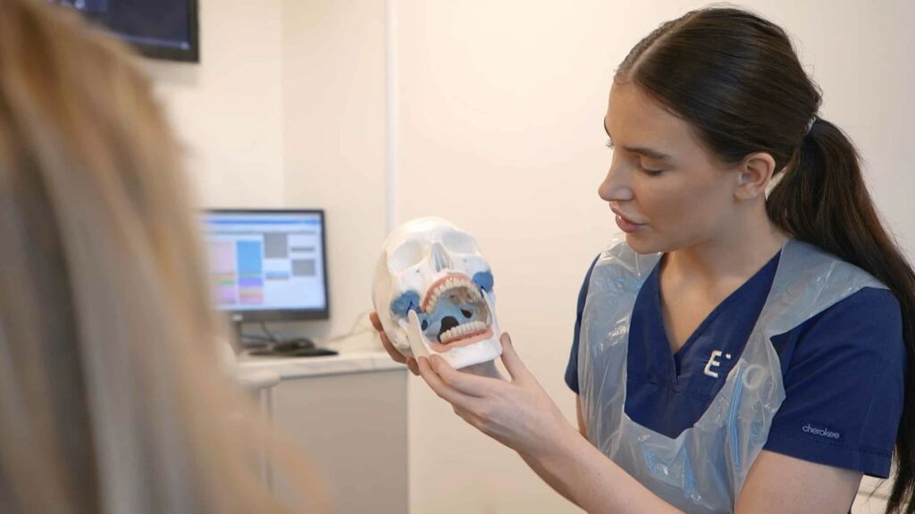 nurse describes all on four dental implants to patient in liverpool clinic