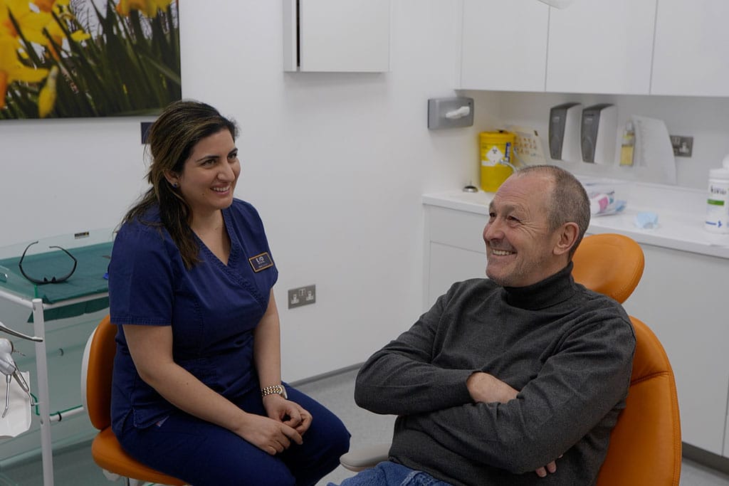 smiling dental implants patient with dentist