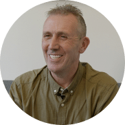 Man smiling in a green shirt with nice teeth